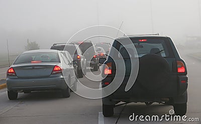 Heavy morning traffic negotiating foggy conditions Stock Photo