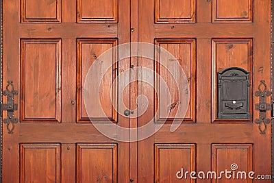 Heavy Paneled Double leaf Mahogany Hardwood Door With Iron Mailbox Stock Photo