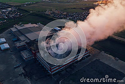 Heavy smoke in burning industrial warehouse or storehouse industrial hangar from burned roof, aerial view of fire disaster Stock Photo