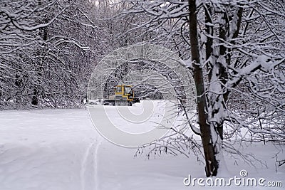 14.12.2021. Heavy snowfall in Moscow. Snowcat ratrak rides up the hill and preparation ski slope Editorial Stock Photo