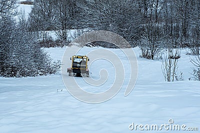 14.12.2021. Heavy snowfall in Moscow. Snowcat ratrak rides up the hill and preparation ski slope Editorial Stock Photo