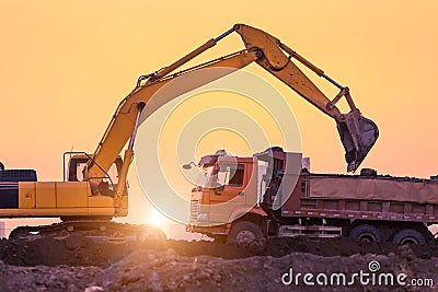 Heavy wheel excavator machine working at sunset Stock Photo