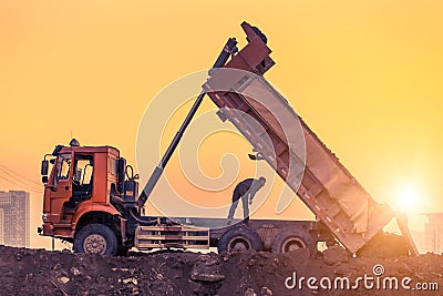 Heavy wheel loader machine working at sunset Editorial Stock Photo