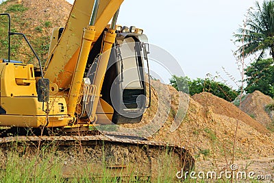 Heavy yellow excavators moving to the parking. Stock Photo