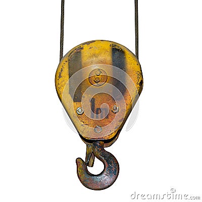 Heavy yellow rusted crane hook of an old factory isolated Stock Photo