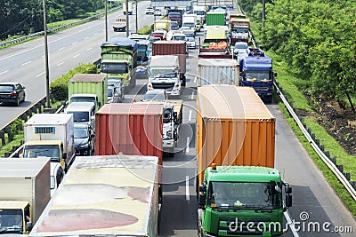 Hectic traffic in a tollway with long row of trucks Stock Photo