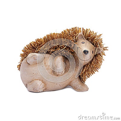 Hedgehog on a white background. The hedgehog lies on its side, a decorative figurine for the interior, a toy Stock Photo