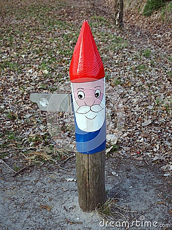 Painted gnome direction sign on a hiking track Editorial Stock Photo