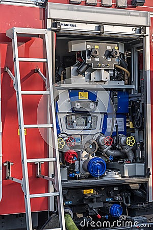 Open back side of German fire truck with water supply connection. Vertical Editorial Stock Photo