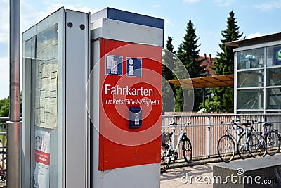 Red German train ticket machine and timetable at railroad station Editorial Stock Photo