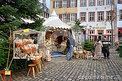 Sales booth with wooden local made producs at square called `Kornmarkt` as part of traditional Christmas market in city center Editorial Stock Photo