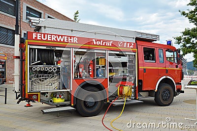 Open red german fire truck with different hoses and fire fight equipment Editorial Stock Photo