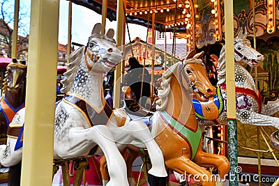 Horses of antique carousel as part of traditional Christmas market in Heidelberg city center Editorial Stock Photo