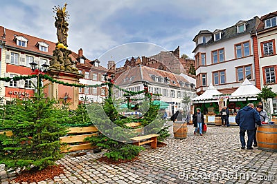 `Winter woods` with multiple fir trees standing around fountain with Madonna statue at square called `Kornmarkt` as part of tradit Editorial Stock Photo