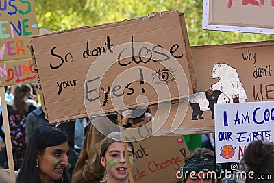 Protest sign saying `So don`t close your eyes` held up by young people during Global Climate Strike and Fridays for future protest Editorial Stock Photo