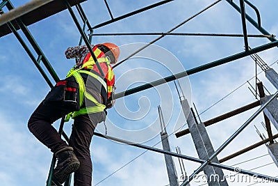 Heights of workers in safety clothing at the construction site Stock Photo