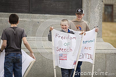 Helena, Montana - April 19, 2020: Boys children smile and laugh holding freedom of speech signs at a protest at the Capitol over Editorial Stock Photo