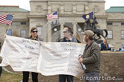 Helena, Montana - April 19, 2020: A man an woman protestor holding banners of the Bill of Rights in front of the Capitol building Editorial Stock Photo