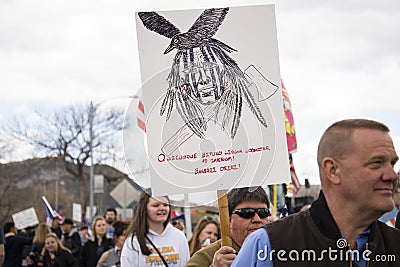Helena, Montana - April 19, 2020: A Native American protestor holding sign that reads Government speaks with a forked tongue. Editorial Stock Photo