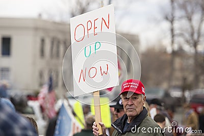 Helena, Montana - April 19, 2020: Protestor holding sign at a protest rally over the shutdown and stay at home orders due to fear Editorial Stock Photo