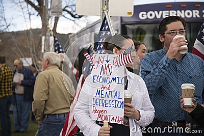 Helena, Montana - April 19, 2020: A women at a protest holding economic and mental depression sign at a demonstration in Editorial Stock Photo