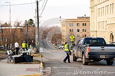 Helena, Montana / November 3, 2020: Election Day voting at polling station outside, woman poll worker in yellow vest wearing a Editorial Stock Photo