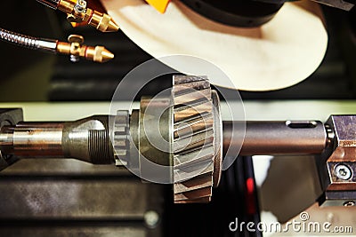 Helical tooth gear manufacturing. Grinding machine Stock Photo