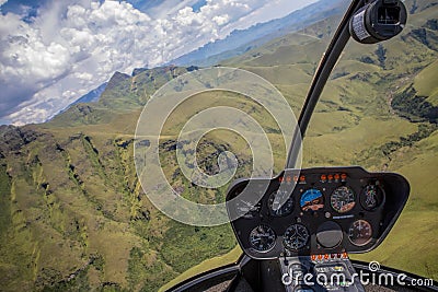 Helicopter cockpit view flying over mountains Stock Photo