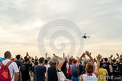 Helicopter demonstration on sky with huge Turkish flags, on the liberty day of Izmir. Crowd people in the frame with Turkish flags Editorial Stock Photo