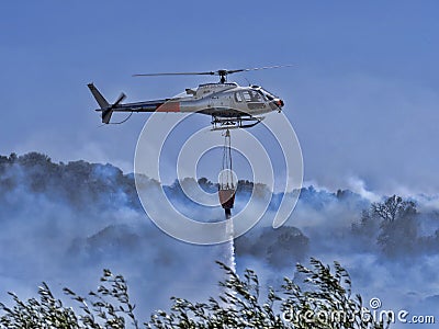Helicopter extinguishes fire July 13, 2012, Tortoli, Sardinia, Italy Editorial Stock Photo