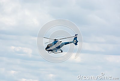 Helicopter flies among the clouds Stock Photo