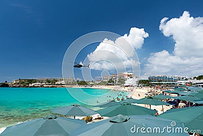 Helicopter flies over the beach, Maho bay, Caribbean Editorial Stock Photo