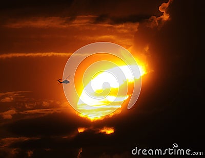 Helicopter flying at sunset Stock Photo