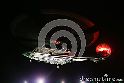 Helicopter landing in offshore oil and gas platform on deck or parking area. Helicopter night flight training of pilot Stock Photo