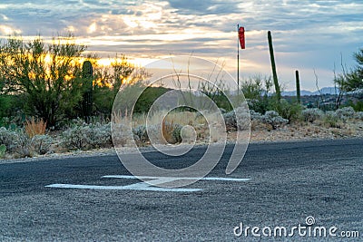 Helicopter landing pad with giant H letter with white paint on cement and gravel for helicopters and saftey and rescue Stock Photo