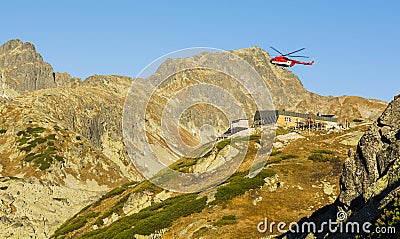 Helicopter OM- EVA Type Mil Mi-8T above the shelter Zbojnicka chata in the mountains. Tatra Mountains. Editorial Stock Photo