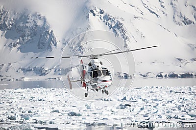 Helicopter over the frozen Arctic fjord Stock Photo