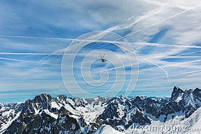 Helicopter over mountain peaks Stock Photo