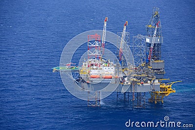 Helicopter pick up passenger on the offshore oil rig. Stock Photo