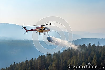 Helicopter squirting water into the forest Stock Photo