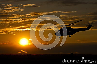 Helicopter at sunset Stock Photo