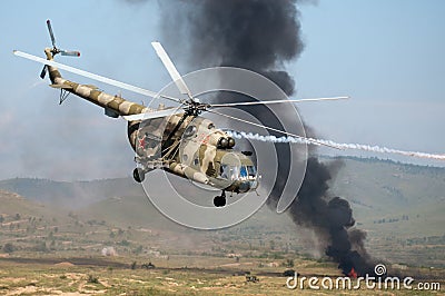 Helicopters mounting a ground attack with explosions and smoke Editorial Stock Photo