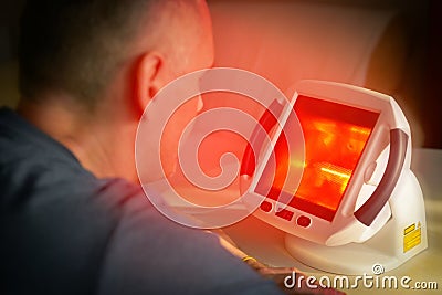 Heling pain with infrared light therapy Stock Photo