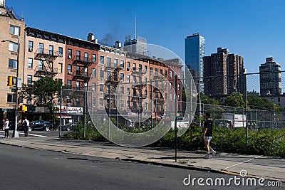 Hell's Kitchen Neighborhood Scene with a Vacant Lot and Old Brick Apartment Buildings Editorial Stock Photo