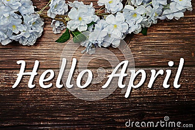 Hello April text and spring flower decoration on wooden background Stock Photo