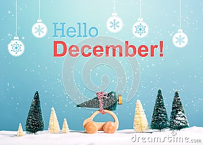 Hello December message with car carrying a Christmas tree Stock Photo