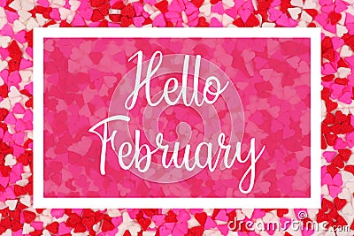 Hello February greeting card with white text over a candy heart background Stock Photo