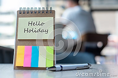 Hello Holiday text on note paper or empty reminder template on wooden table. New Goal New Start concept Stock Photo