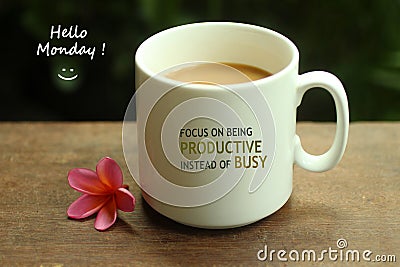 Hello Monday coffee. White mug of coffee and positive inspirational quote on it - Focus on being productive instead of busy. Stock Photo