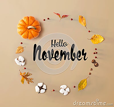 Hello November message with autumn leaves and orange pumpkin Stock Photo